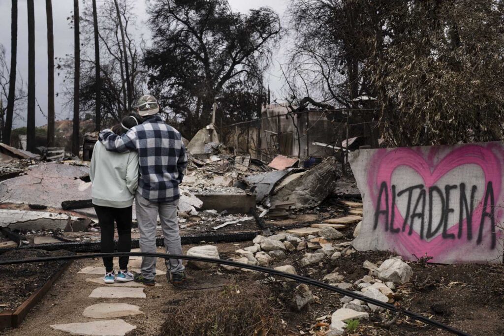 Couple looking at the ashes of their home - Future Proof by The Paulele Hale Organization